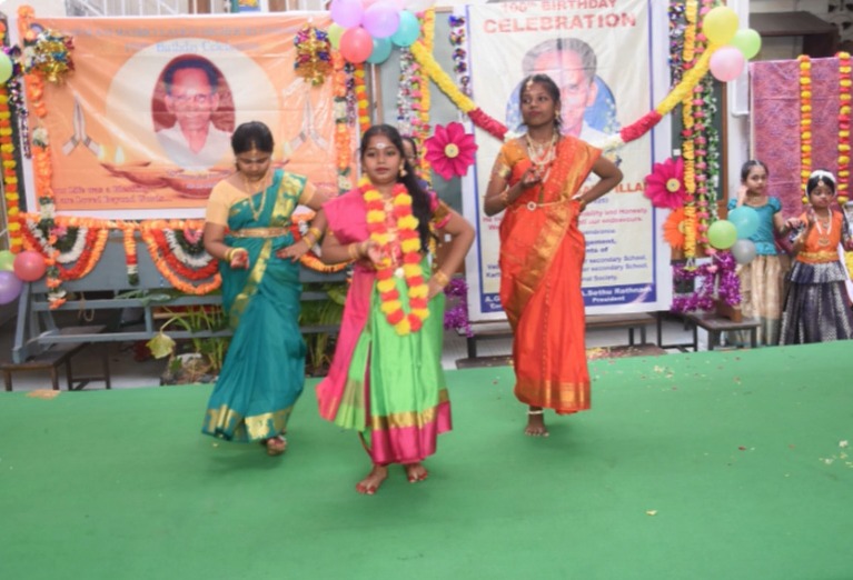 Students performing a cultural dance on stage